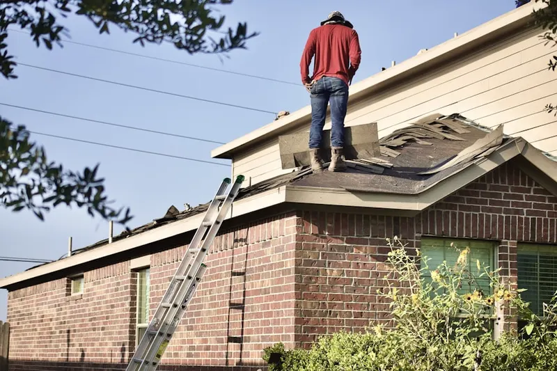 Professional roofer working on a residential roof in Akins Corners